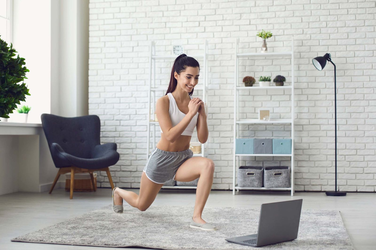 woman doing leg workout in living room on grey carpet